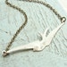 Flying Sparrow Necklace. Weathered cream color. Antique brass chain.