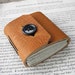 Honey Button Journal - thick brown leather with a black button closure.