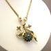 Vintage gold tone necklace with floral spray pendant and multi color rhinestones