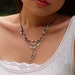White Y necklace with cascading garland in gunmetal black chain