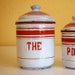 RESERVED FOR A. French enamelware canister, the (tea), white with red stripes, gold pin stripes