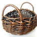 Vintage wicker basket. Oval shaped with handles. Country, cottage, garden, more.