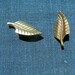 Pair of Leaf pins, stylized 1950s design, brass.