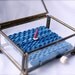 red sailboat automaton in glass jewelry box