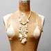 vintage 1970s necklace. elephants of carved bone stament piece.