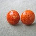 Round plastic button style coral orange swirl post back earrings