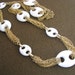Fun long gold tone vintage necklace with white oval loops