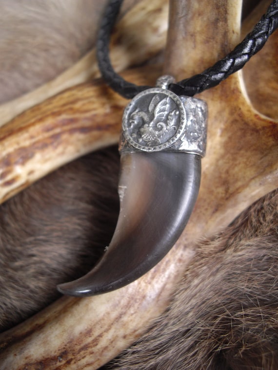 real bear claw set in a pure silver cap with a dragon