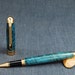 Designer Rollerball with Teal colored Curly Maple body and 24k Gold plating