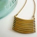 Brass geometric necklace with military style curved brass bars. Stacked bar necklace.