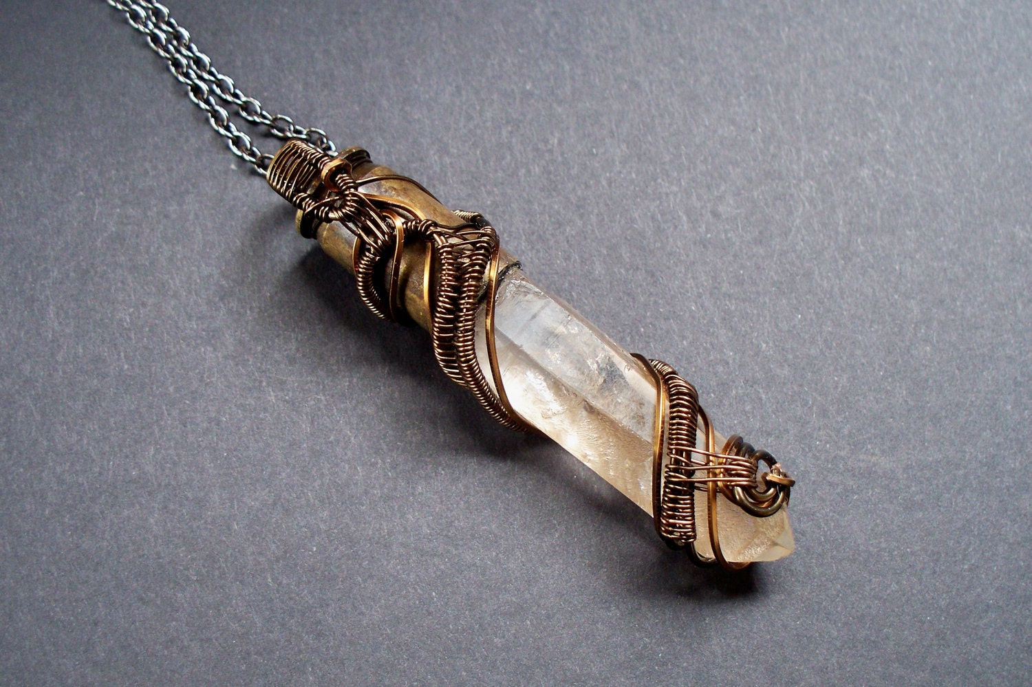 Quartz crystal point wire wrapped 45 caliber bullet pendant