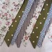 Bunting, Flags the fabrics are mainly Olive Green,Chocolate Brown and Pale blue in Spots, Flowers and Gingham and its 3m long.