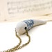 Tribal tusk or tooth with blue geometric pattern diamonds circles