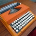 Reserved for Kathy - Orange Olivetti Typewriter PROFESSIONALLY SERVICED including new rubber platten