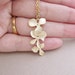 Beautiful Orchid Trio . Matte gold plated triple orchid charm Necklace
