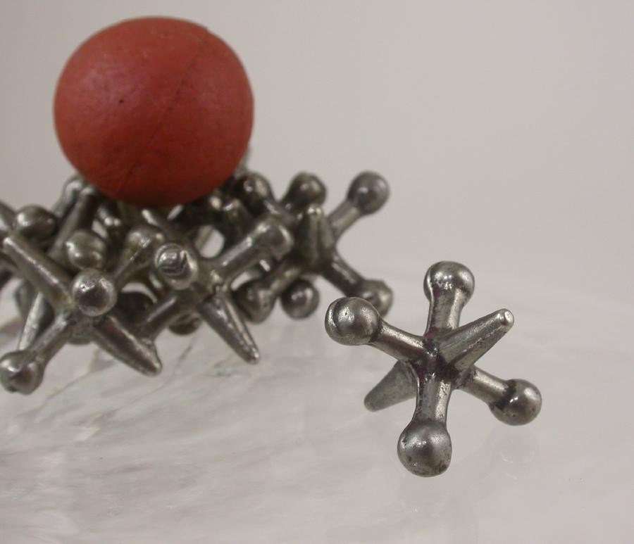 Antique Jacks. Set of 10 thick steel jacks with original