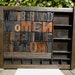 Well behaved women rarely make history, a collage of vintage wooden print blocks set in a type tray / case