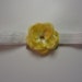 Small Yellow flower on a shimmery elastic band fits ages newborn-18 months. Perfect photo prop with my rompers, more colors available