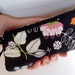 Black wristlet with flowers birds and butterflies