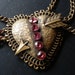 wonderful art deco brass festoon heart necklace with pink rhinestones