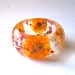 Red and Yellow Botanical Resin Bangle. Real Flowers - Red Baby's Breath and Yellow Cosmos. Personalized Jewelry. Custom Engraving.