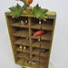Vintage Coca-Cola crate upcycled into curio cabinet with cuckoo clock details