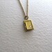 Tiny book locket necklace on antiqued gold metal chain, upcycled vintage jewelry
