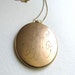 FOR KATHLEEN: Antique gold oval monogram locket on long chain, signed W & H Co.