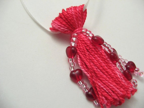 Pink tassel beaded with red hearts
