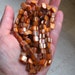Two Strands of Iridescent Earthy Orange Shell Beads