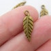10 Leaf charms ( double sided ) 19 x 6mm antique bronze tone ( FREE combined shipping )