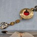 THE TIME KEEPER antique gold tone vintage watch casing steampunk watch movement necklace with vintage red glass cab