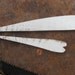 2 skinny white wooden hearts