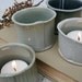 Group of four porcelain tealight or votive candleholders