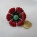 Tiny red enamel flower lapel pin brooch with green center and gold dangle