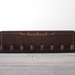 Brown Wood Peg Rack with Gold Trim