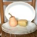 Four large oval restaurant ware dinner or breakfast plates by Homer Laughlin. Chop plates, diner, classic, simple, scalloped, mustard yellow