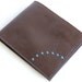Brown leather wallet with plain sky blue lining cards coins