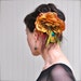 Caramel and warm brown flower clip with peacock and wine ostrich feathers. Embellished with brass peacock rhinestone pin. Vintage look.