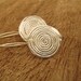 Flat Silver Swirling Earrings with Circle Design