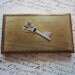 small metal box - gold tone with heart shaped key embellishment
