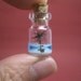 A turtle in an uninhabited island with a palm tree in a tiny bottle blue ver.2