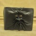 Grichels leather bi-fold wallet - black with bronze speckled slit pupil reptile eyes