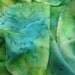 Blues greens and yellows merge on square silk scarf