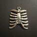 Pair of antique silver ribcage pendants