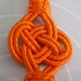 Two tangerine art silk tassels