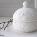 Vintage Milk Glass Jar Embossed Powder Jar Hair Keeper Floral Motif Avon from Tessiemay