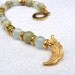Bracelet in sage green and light blue semi precious stones with gold