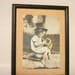 Framed vintage photo in sepia, black and white photograph of a girl playing a trumpet