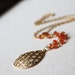 Orange carnelian beaded gold necklace with a marquise cutout teardrop pendant N92-G